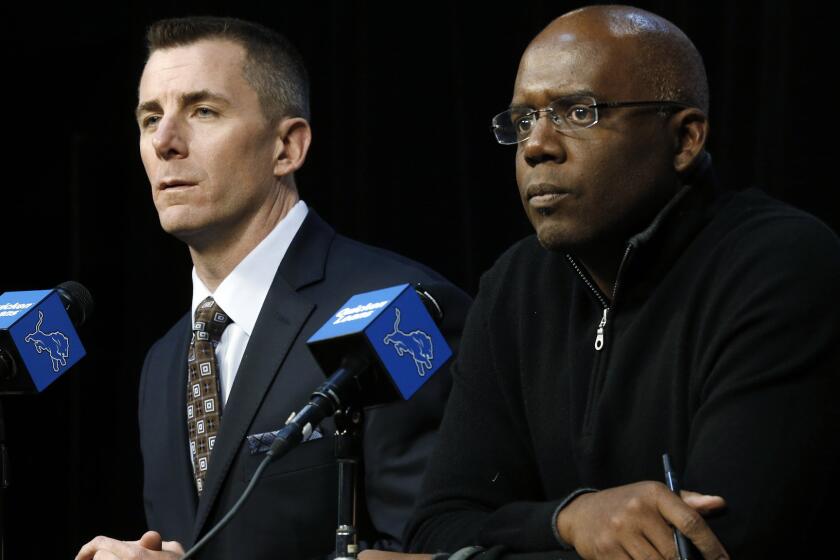 Tom Lewand, left, and Martin Mayhew address reporters during a news conference on Dec. 30, 2013.