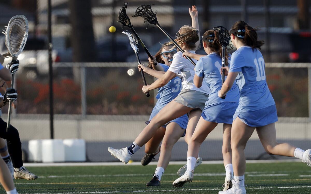 Newport Harbor High's Reese Vickers, third from right, scores against Corona del Mar during the first half of a Sunset League game at Davidson Field on Thursday.