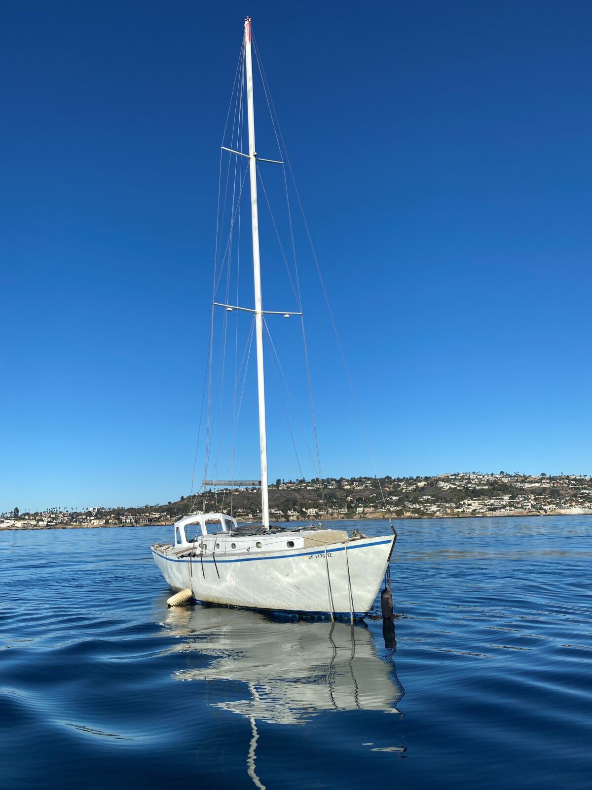 An empty sailboat anchored off the coast of Bird Rock is pictured Nov. 13. It was towed away a few days later.