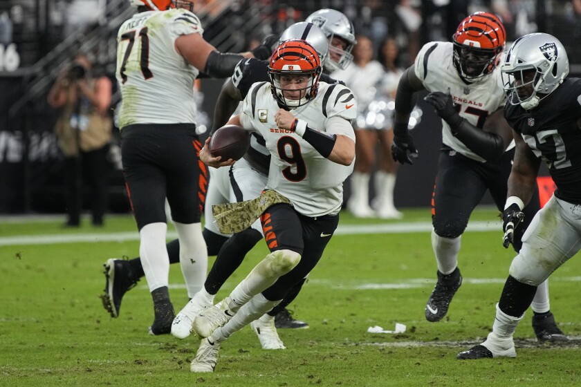 Bengals quarterback Joe Burrow (9) escapes the rush and runs for yardage against the Raiders in November.