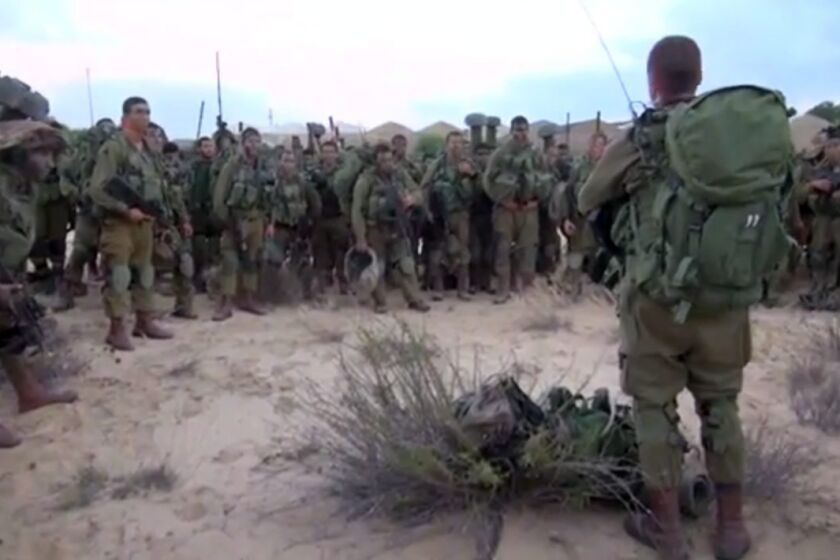 Israeli infantry soldiers receive a briefing in the Gaza Strip on July 18.