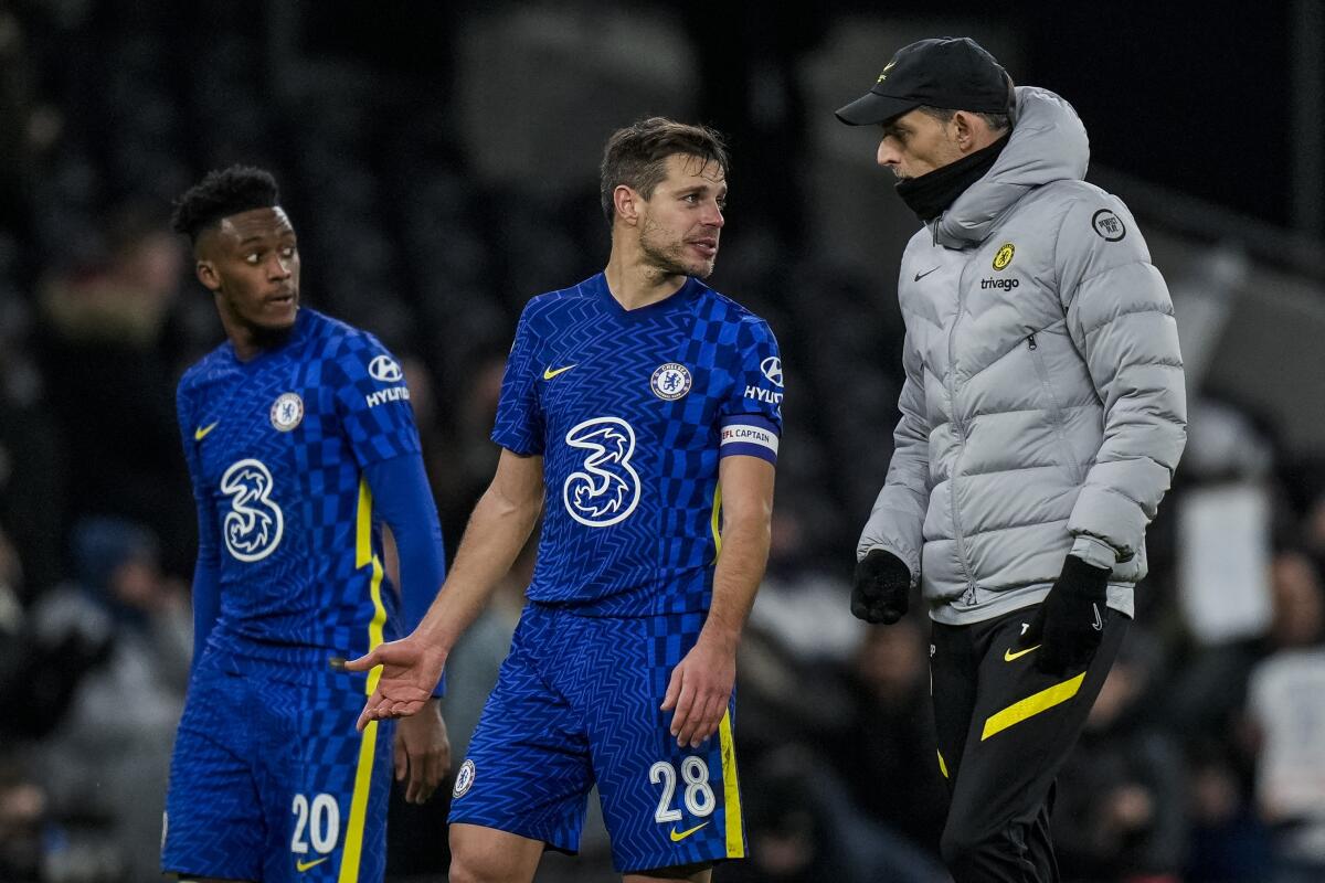 Chelsea's head coach Thomas Tuchel, right, talks to Chelsea's Cesar Azpilicueta after the English League Cup semifinal second leg soccer match between Tottenham Hotspur and Chelsea at the Tottenham Hotspur Stadium in London, Wednesday, Jan. 12, 2022. (AP Photo/Alastair Grant)