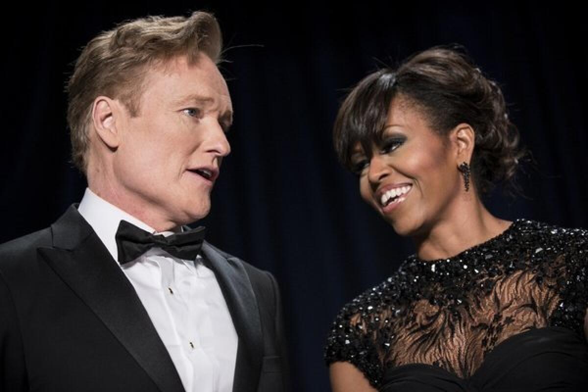 TV host Conan O'Brien and First Lady Michelle Obama speak during the White House Correspondents' Association Dinner on April 27, 2013, in Washington, D.C. Obama attended the yearly dinner attended by journalists, celebrities and politicians.