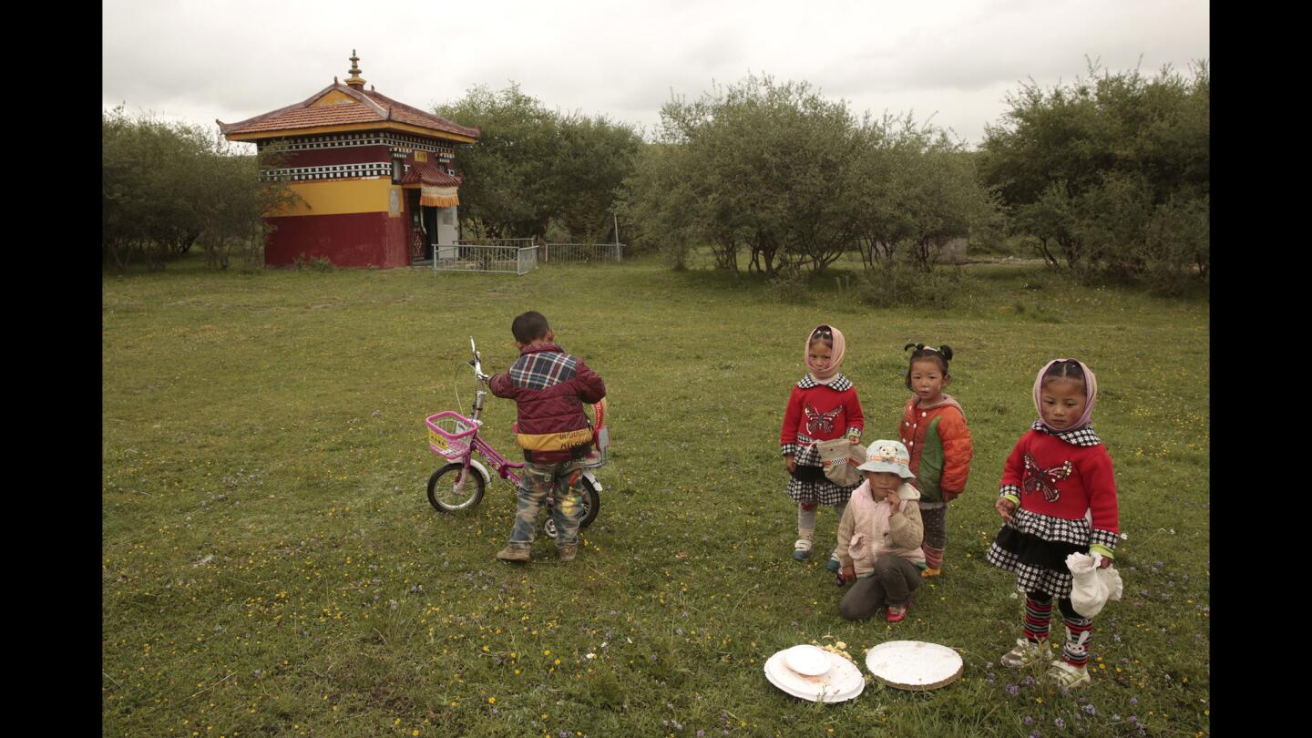 Young Tibetans near shrine