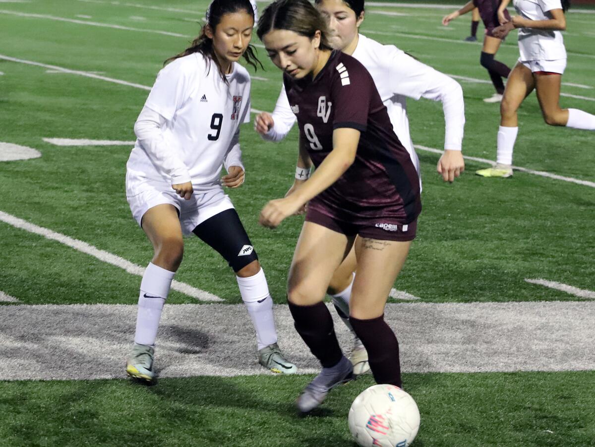 Ocean View's Jizelle Ruiz (9) tries to dribble past Katella defenders during Tuesday night's match.