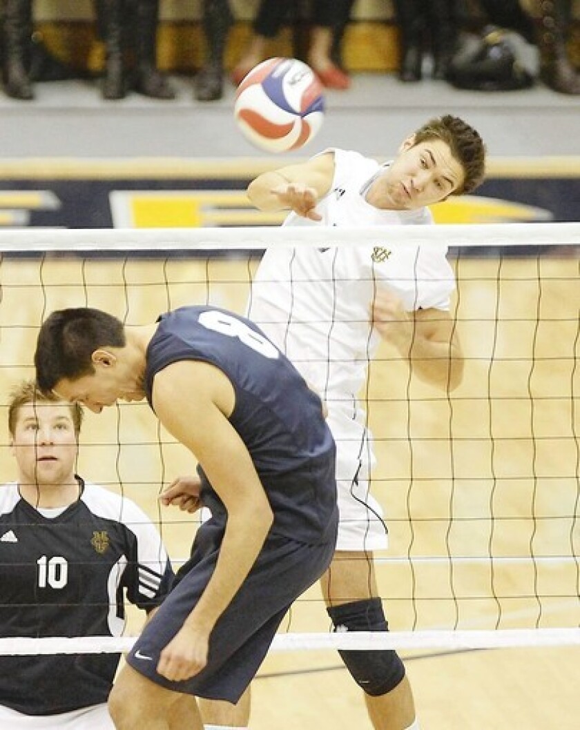 UCI's Kevin Tillie gets a kill past BYU's Joe Kauliakamoa, who wants no part of the play.