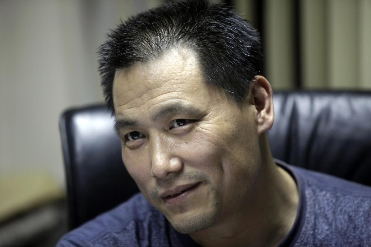In this 2010 file photo, Chinese attorney Pu Zhiqiang speaks during an interview at his office in Beijing.
