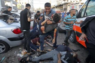 A man steps over the bodies of dead and injured Palestinians lying on the ground following an Israeli airstrike outside the entrance of the al-Shifa hospital in Gaza City, Friday, Nov. 3, 2023. (AP Photo/Abed Khaled)