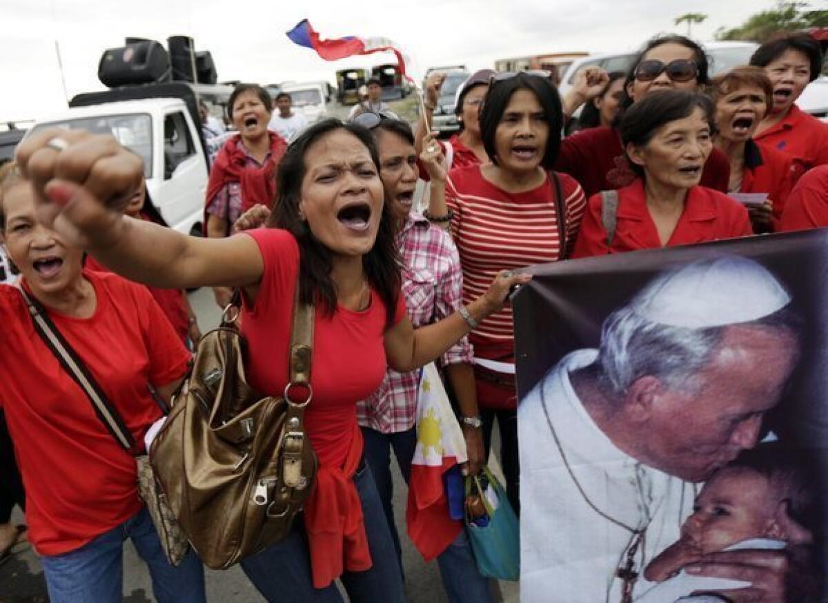 Filipino Catholics stage a demonstration against the passing of a reproductive health law in front of the Senate building in Pasay City.