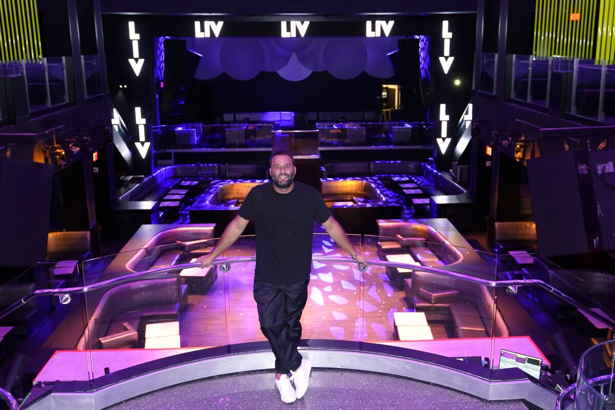 LIV owner David Grutman poses for a photograph at the nightclub, Wednesday, Oct. 14, 2020, in Miami Beach, Fla. LIV, one of Miami's most glamorous, star-studded nightclubs sits empty and quiet these days, a casualty of both the coronavirus outbreak and a power struggle between state and local government over how to contain the scourge. (AP Photo/Lynne Sladky)