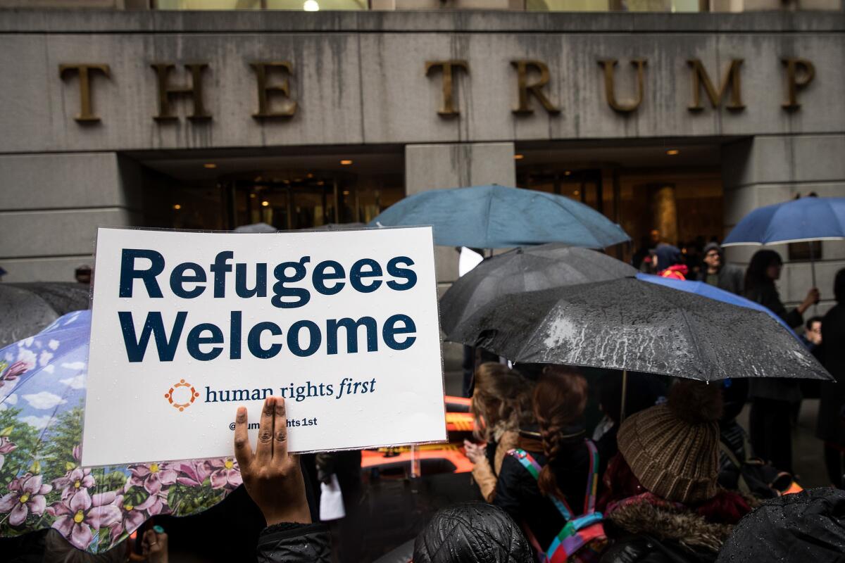 Protesters rally in front of the Trump Building on Wall Street in New York during a March 28 protest against the Trump administration's travel ban and refugee policies.