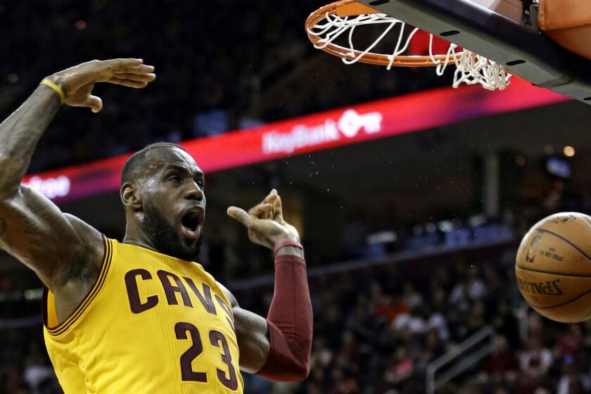 Cavaliers forward LeBron James reacts after dunking the ball against the Nets in the first half Thursday.