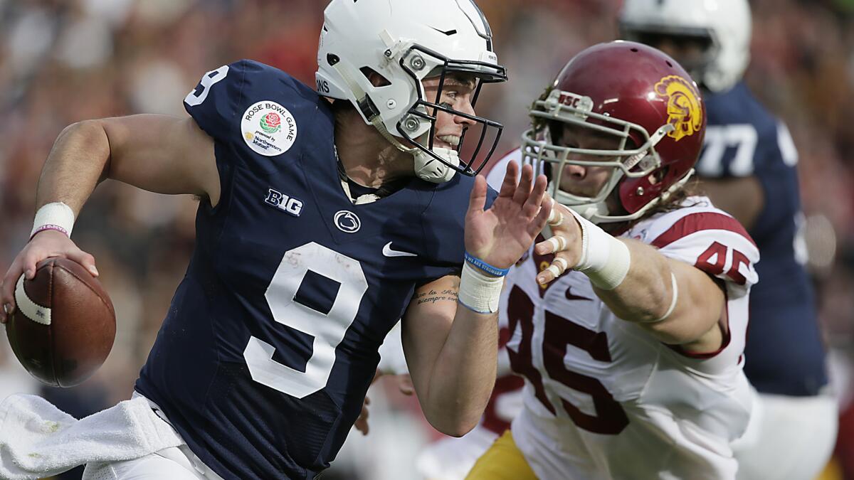 Penn State quarterback Trace McSorley eludes the tackle of USC end Porter Gustin in first quarter.