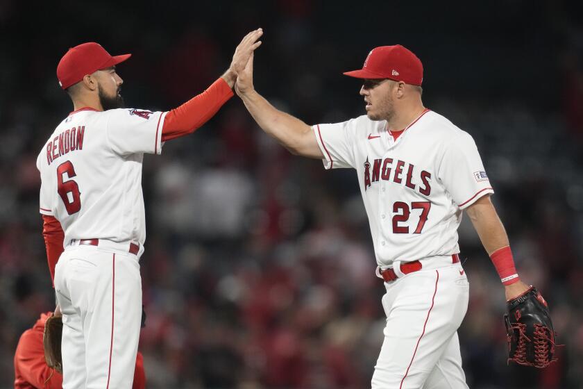 Los Angeles Angels third baseman Anthony Rendon (6) and center fielder Mike Trout (27) celebrate after a 5-3 win over the Oakland Athletics in a baseball game in Anaheim, Calif., Tuesday, April 25, 2023. (AP Photo/Ashley Landis)