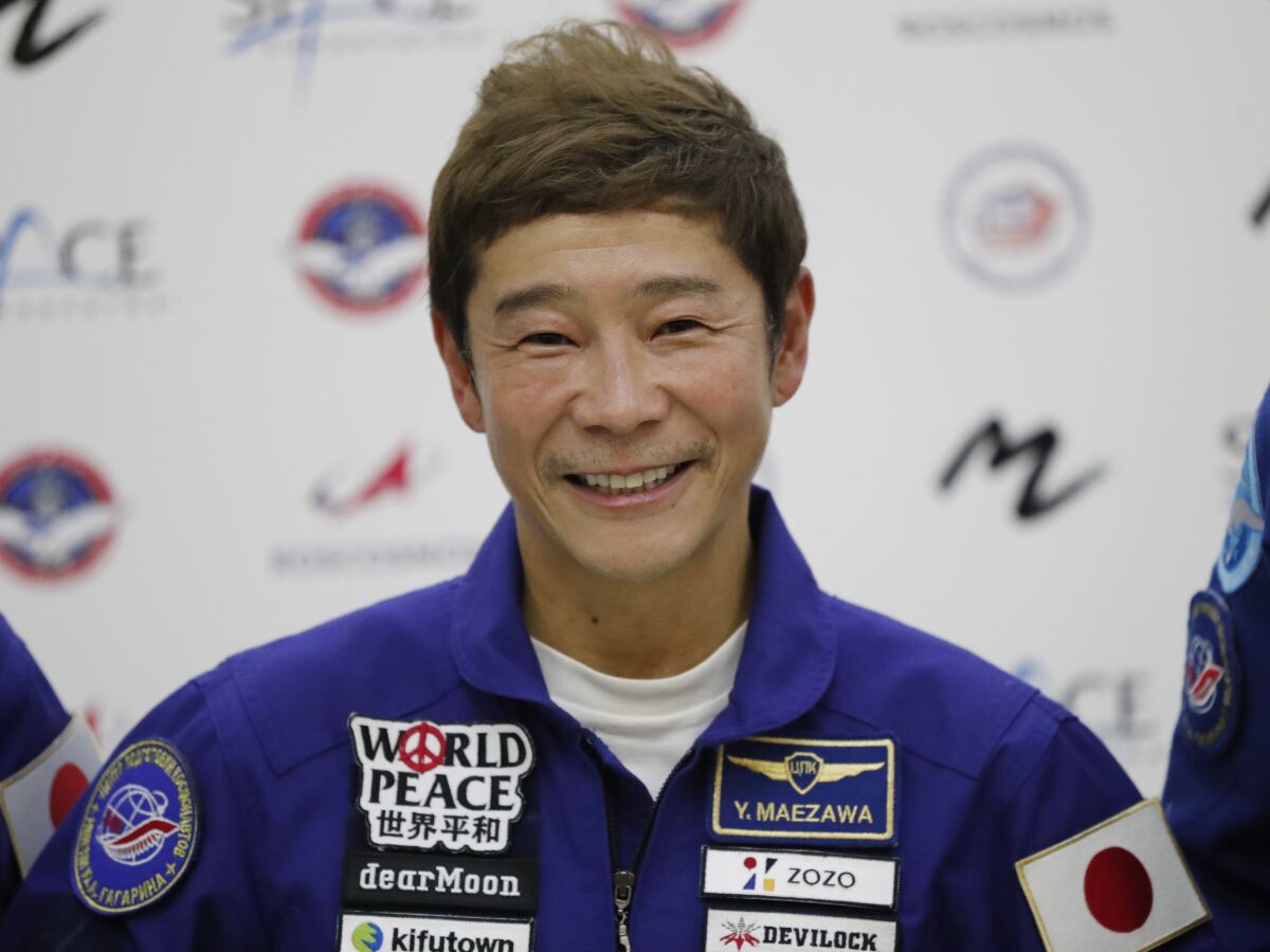 FILE - Space flight participant Yusaku Maezawa attends a news conference ahead of the expedition to the International Space Station at the Gagarin Cosmonauts' Training Center in Star City outside Moscow, Russia, on Oct. 14, 2021. Maezawa said Friday, Dec. 9, 2022 that K-pop star TOP will be among the eight crew members who will join him on a flyby around the moon on a SpaceX spaceship next year. (Shamil Zhumatov/Pool Photo via AP, File)
