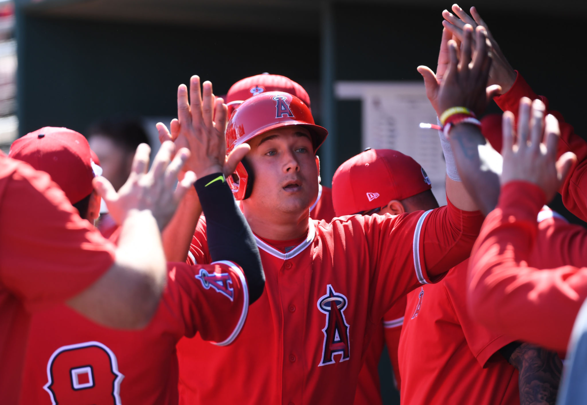 Angels' Matt Thaiss celebrates with teammates in the dugout.