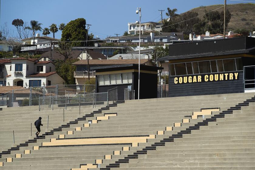 VENTURA, CA-MARCH 30, 2020: A man runs up the steps while working out at Larrabee Stadium that is part of the Ventura High School campus. The stadium is closed as a result of the coronavirus outbreak but people are climbing over the fence to get inside. (Mel Melcon/Los Angeles Times)
