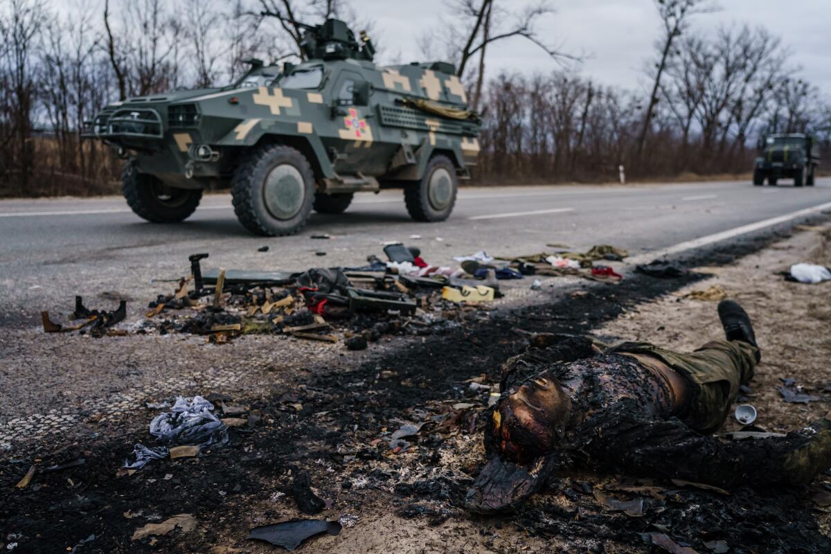 A corpse of a Russian soldier on the side of a road where there was recent heavy fighting