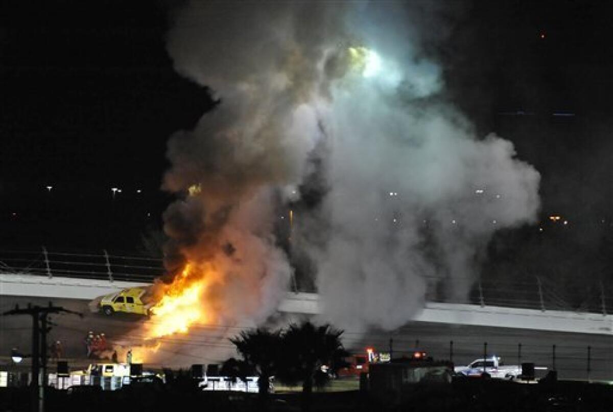Emergency workers put out a fire on a jet dryer during the NASCAR Daytona 500 auto race at Daytona International Speedway in Daytona Beach, Fla., Monday, Feb. 27, 2012. (AP Photo/Rainier Ehrhardt)