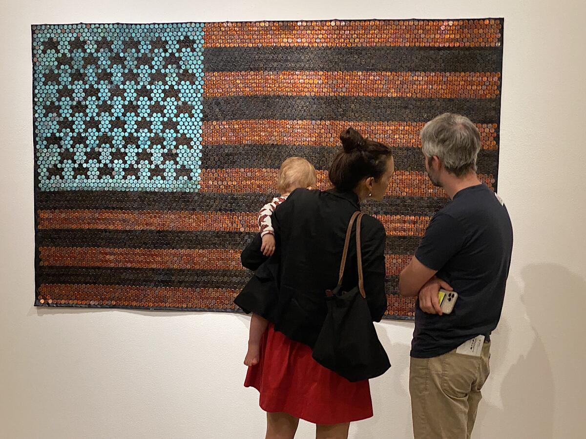 At the evening event, three viewers contemplate Yaw Owusu’s African American Flag.
