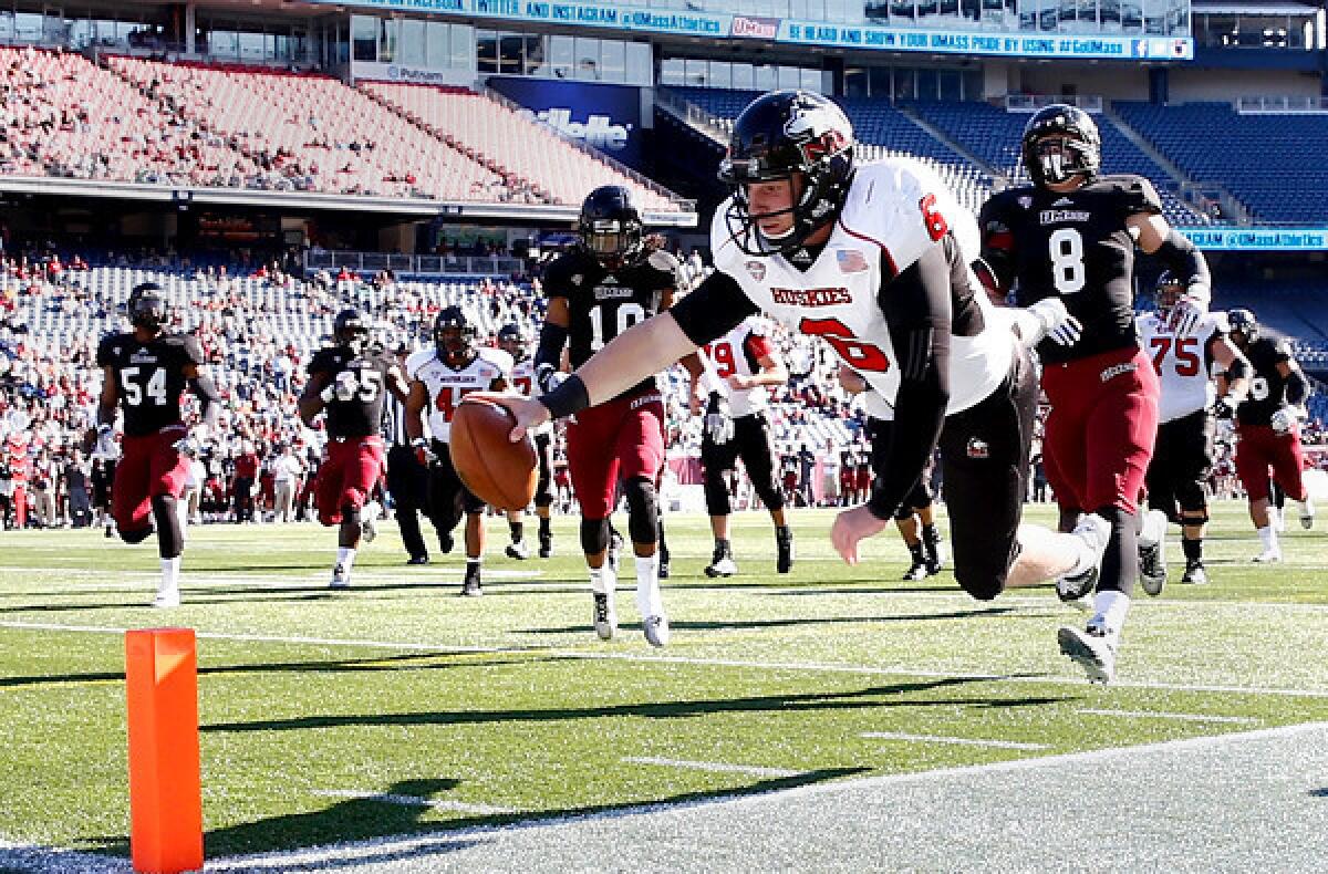 Northern Illinois quarterback Jordan Lynch dives for the goal line as he scores a touchdown against Massachussets in the first quarter Saturday.