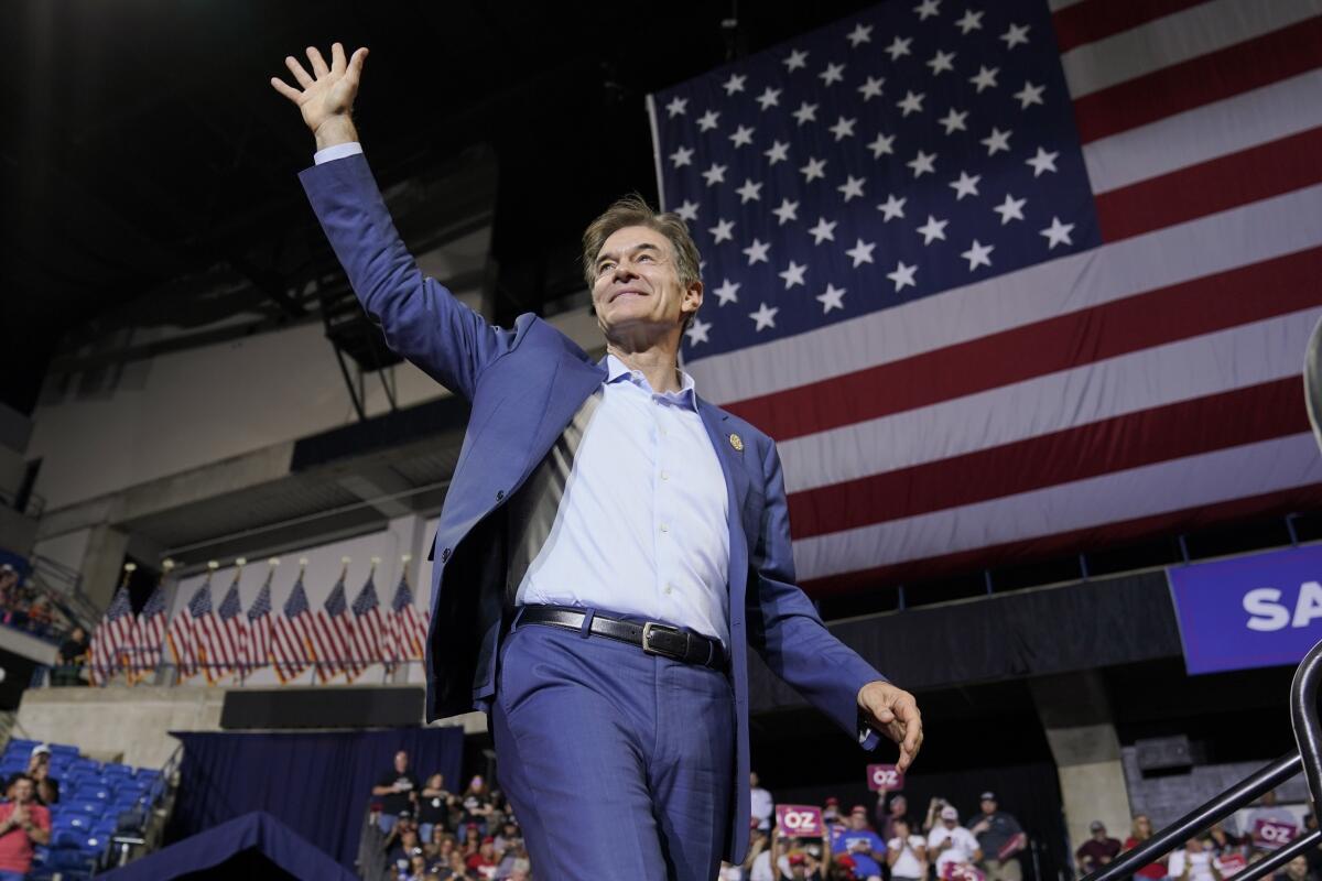 Pennsylvania Republican Senate candidate Dr. Mehmet Oz smiles and waves to a rally crowd. 