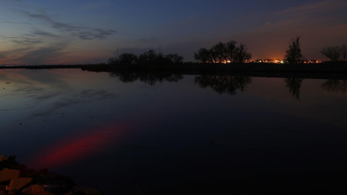 The sunset is reflected in the Middle River in the Sacramento-San Joaquin Delta.
