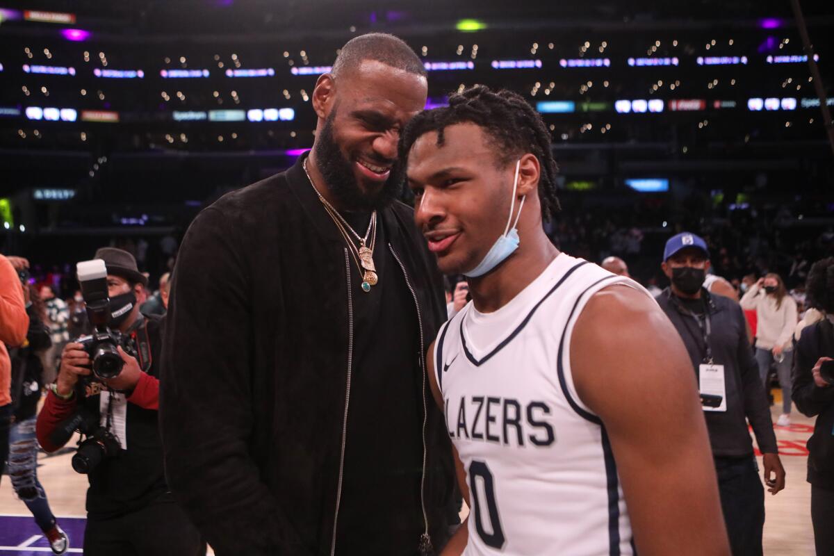 LeBron James congratulates son Bronny, point guard for Sierra Canyon, after his team defeated St. Vincent-St. Mary