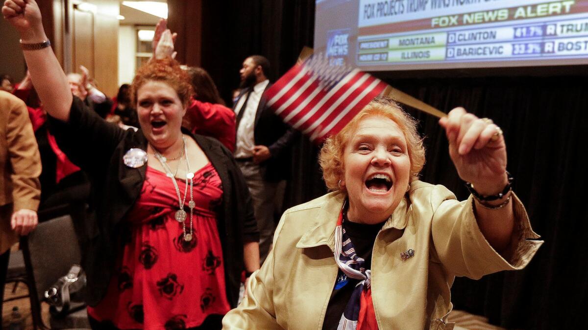 Lyn Thrasher, right, of Greensboro, N.C., and her daughter, Marley Thrasher, left, of Raleigh, watch elections results at a rally for North Carolina Gov. Pat McCrory in Raleigh, N.C.