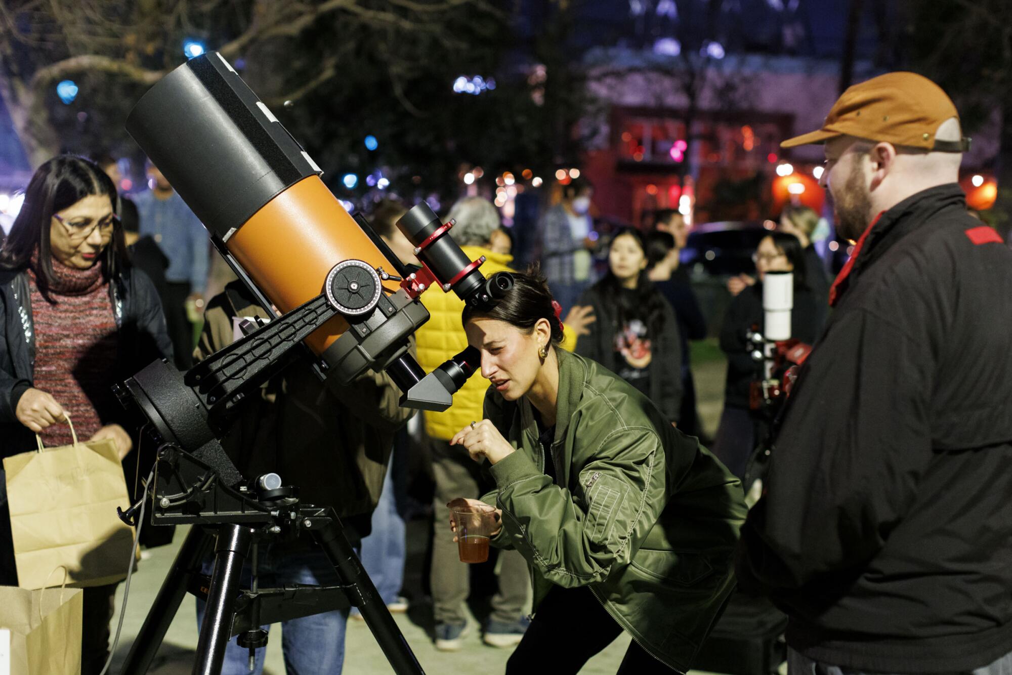 Nora Mae looks through a telescope at Star Party Silverlake, hosted by the Los Angeles Astronomy Society.