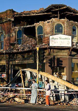 Two women look at the damage in Christchurch, New Zealand, after the early-morning earthquake.