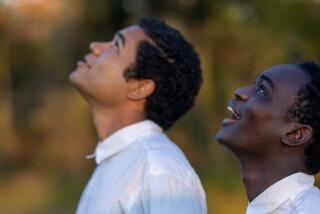 Two boys look skyward.