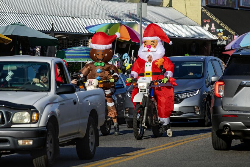 LOS ANGELES, CA-DECEMBER 19, 2022: Motorcycle riders, getting into the Christmas spirit, make their way along Maple St. in downtown Los Angeles. (Mel Melcon / Los Angeles Times)