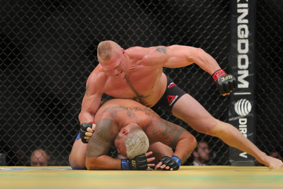Brock Lesnar punches Mark Hunt during their fight in UFC 200 on July 9. Lesnar has since tested positive for a performance-enhancing substance in a sample he submitted June 28.