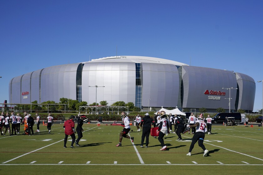 The San Francisco 49ers NFL football team defensive unit runs drills during practice in front of State Farm Stadium, home of the Arizona Cardinals, Thursday, Dec. 3, 2020, in Glendale, Ariz. The 49ers start a three-week road trip after being forced from their stadium and practice facility because of strict new COVID-19 protocols in their home county in Northern California. (AP Photo/Ross D. Franklin)