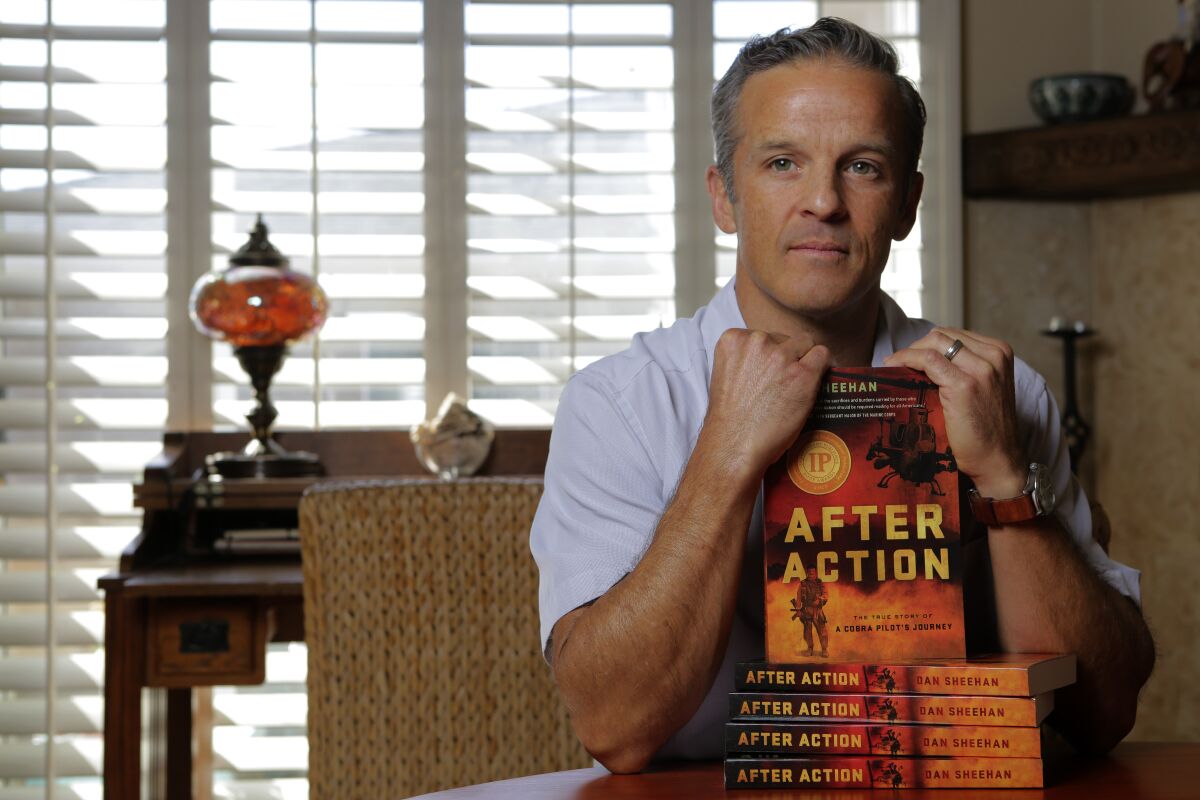 Marine Corps veteran Dan Sheehan at his Encinitas home Monday with the book he wrote, "After Action."