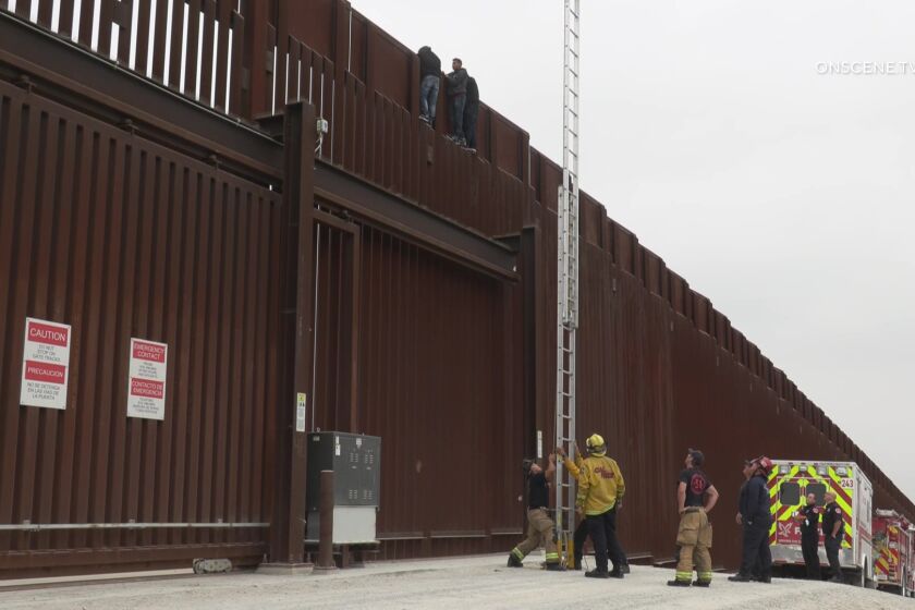 Crews rescue three men from wall along U.S.-Mexico border in Otay Mesa.