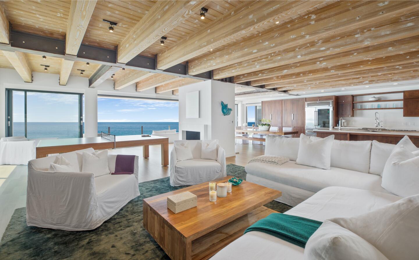The architectural beach house expands to two levels of wood decks overlooking the ocean.