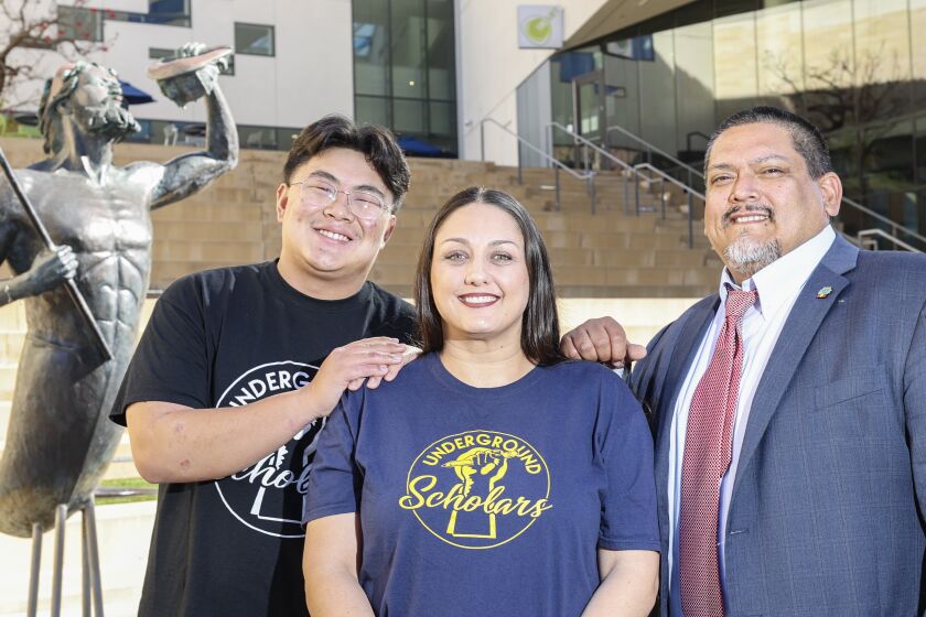 San Diego, CA - March 18: Standing with the UCSD Triton statue, (from left) Aidan Tojino, Jennifer Gomez, Dr. Beto Vasquez pose for photos at UCSD on Friday, March 18, 2022 in San Diego, CA. (Eduardo Contreras / The San Diego Union-Tribune)