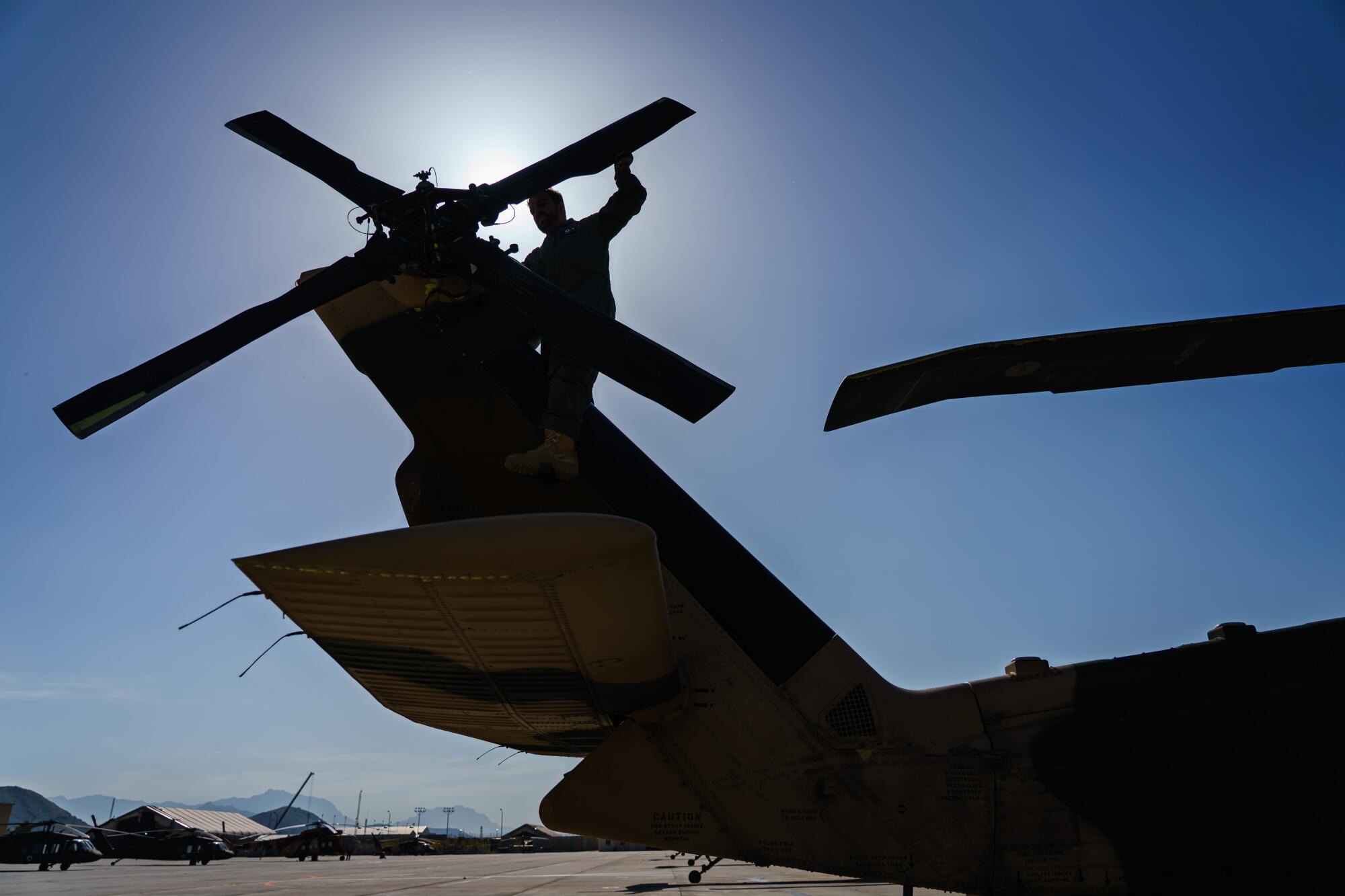 An Afghan air force UH-60 crew inspects the tail rotor during preflight check at Kabul Airbase in Afghanistan. 