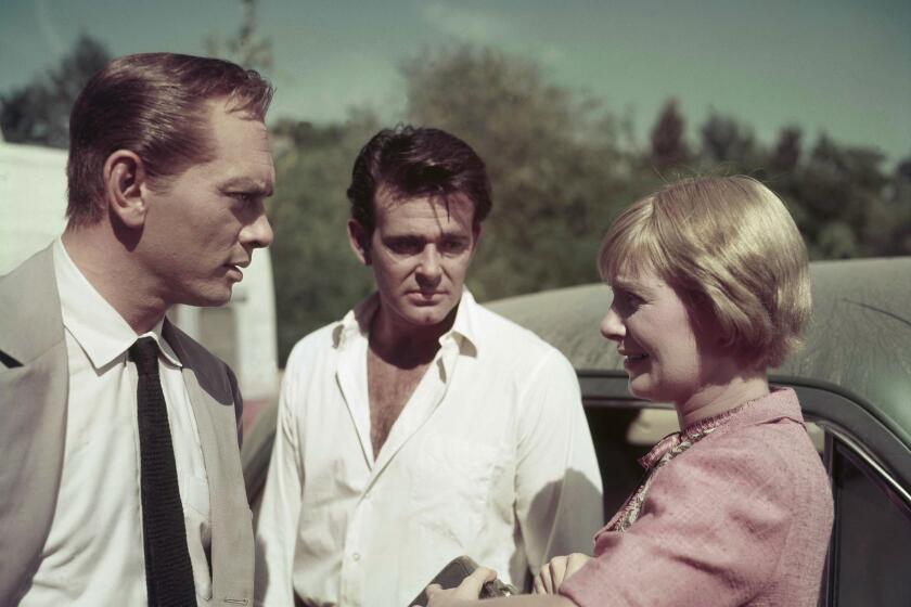 Actors Yul Brynner, left, Stuart Whitman, center, and Joanne Woodward, right, are pictured on the set of the film "The Sound and the Fury", in Louisiana, Dec. 18, 1958. (AP Photo)