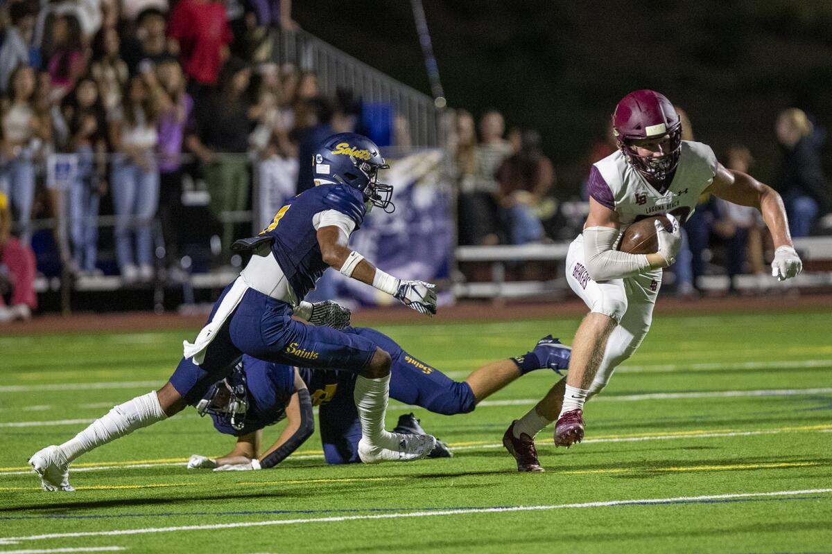 Laguna Beach's Ryner Swanson breaks free from Crean Lutheran's Ben Byszewski during a game on Friday.