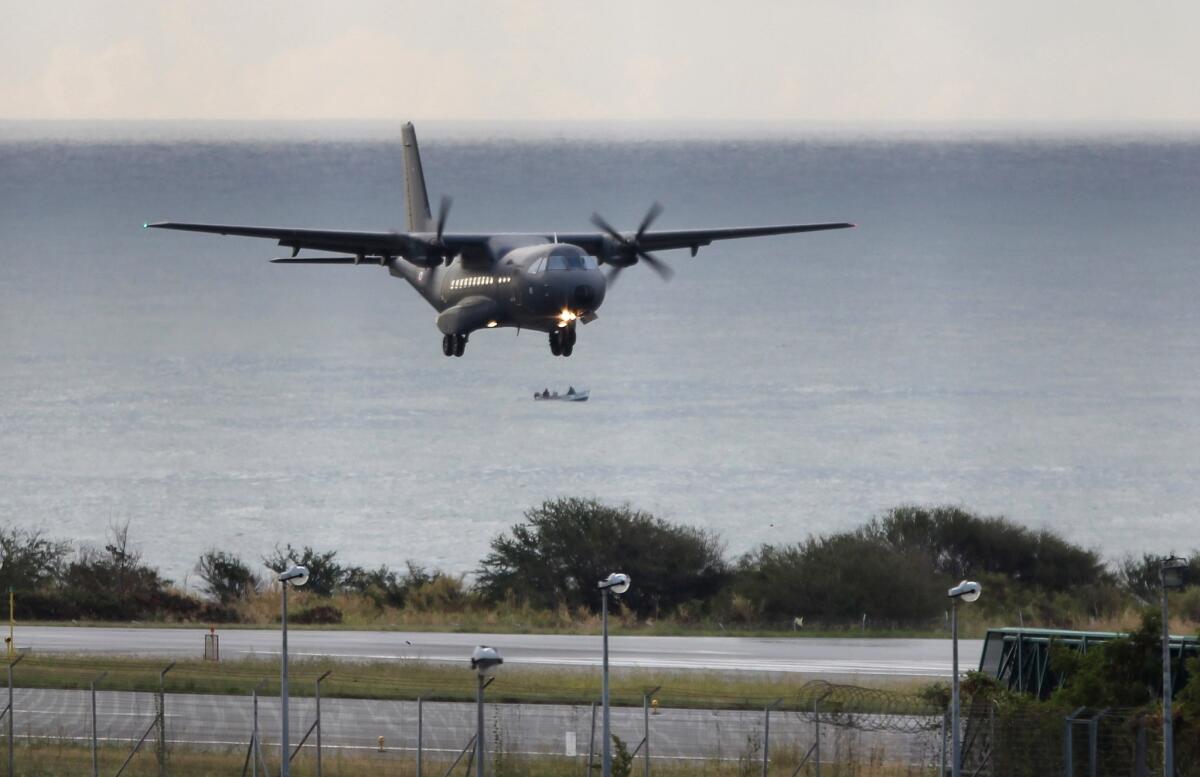 A French Air Force plane taking part in the search for wreckage from Malaysia Airlines Flight 370 lands in Saint-Marie on the French island of Reunion on Friday.