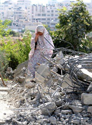 Tuesday: The Day In Photos, Palestinian woman cries after home knocked down.