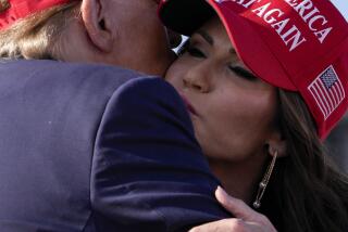 Republican presidential candidate and former President Donald Trump, left, embraces South Dakota Gov. Kristi Noem at a campaign rally Saturday, March 16, 2024, in Vandalia, Ohio. (AP Photo/Jeff Dean)