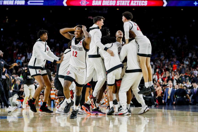 Houston, TX - April 1: San Diego State Aztecs guard Darrion Trammell reacts after guard Lamont Butler hits the game-winning shot at the buzzer to head to the national championship during the semifinal round of the 2023 NCAA Men's Basketball Tournament played between the San Diego State Aztecs and the Florida Atlantic Owls at NRG Stadium on Saturday, April 1, 2023 in Houston, TX. (Meg McLaughlin / The San Diego Union-Tribune)