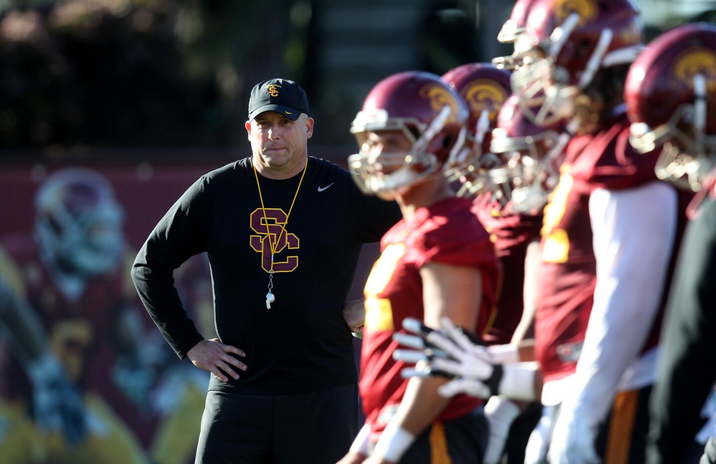 Head Coach Clay Helton watches his Trojan squad on the first day of spring practice at USC's Howard Jones Field.
