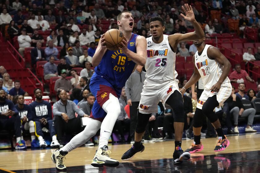 Denver Nuggets center Nikola Jokic (15) drives to the basket as Miami Heat center Orlando Robinson (25) defends during the first half of an NBA basketball game, Monday, Feb. 13, 2023, in Miami. (AP Photo/Lynne Sladky)