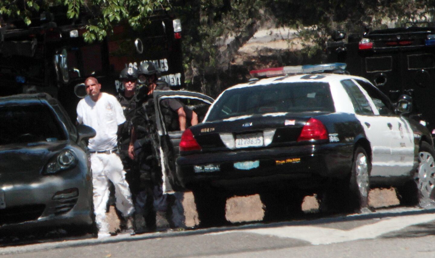 LAPD officers take a suspect into custody after a four-hour standoff in North Hollywood.