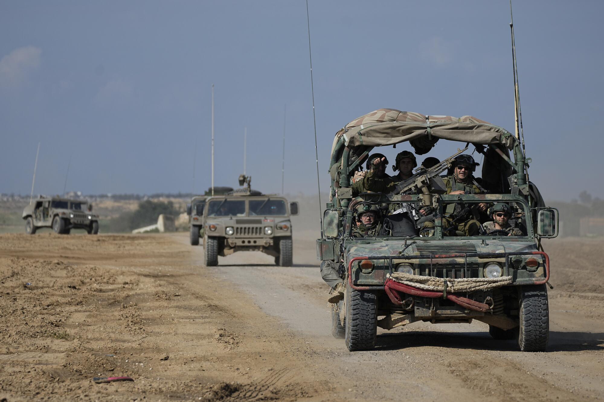 Israeli soldiers in vehicles near the Gaza border